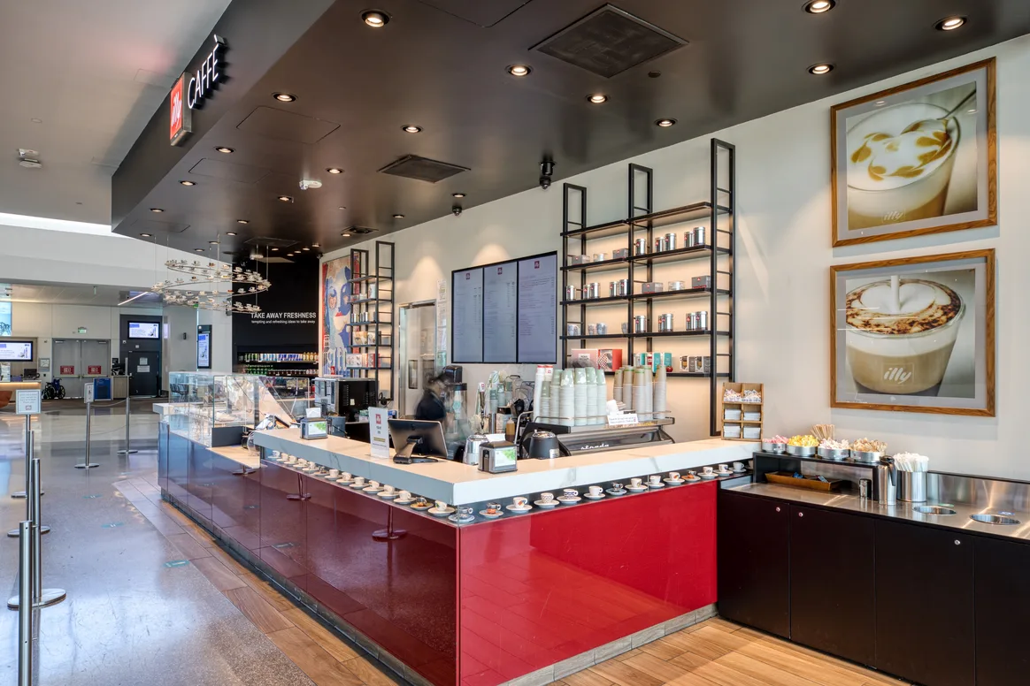 Employee at the espresso bar of Illy Caffè, Harvey Milk Terminal 1