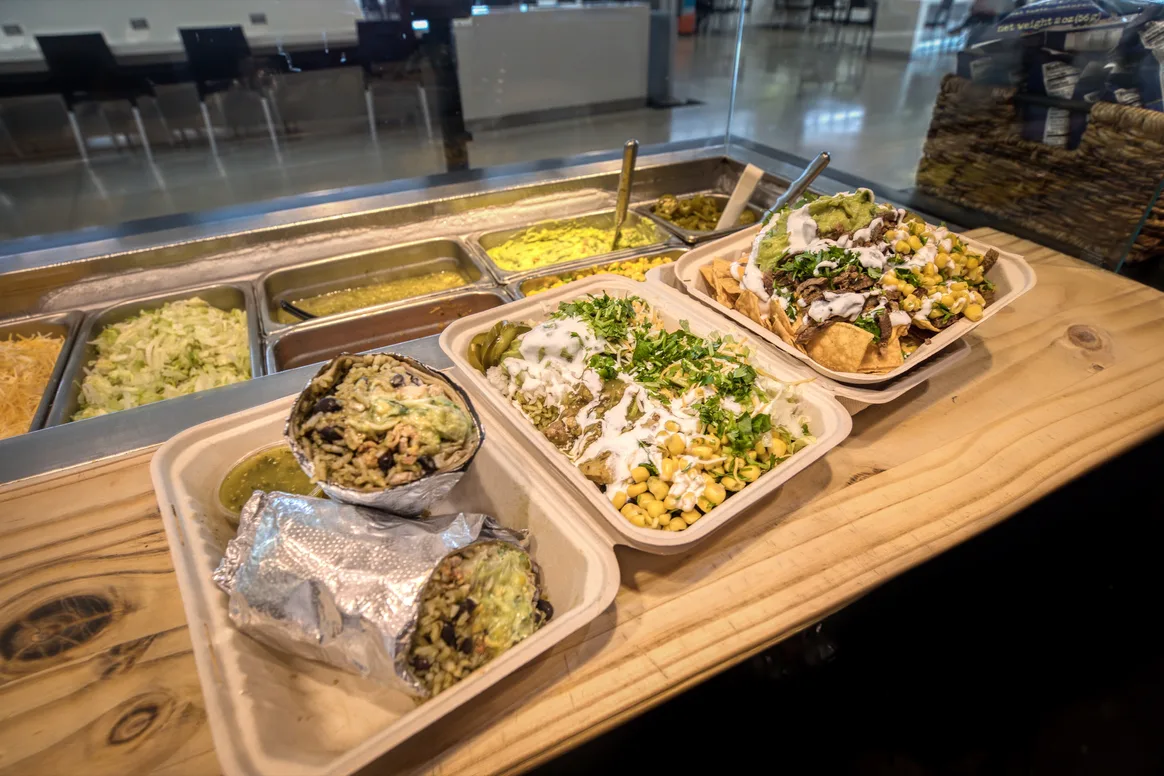 Burritos, salads, and nachos prepared at Urban Tortilla SFO
